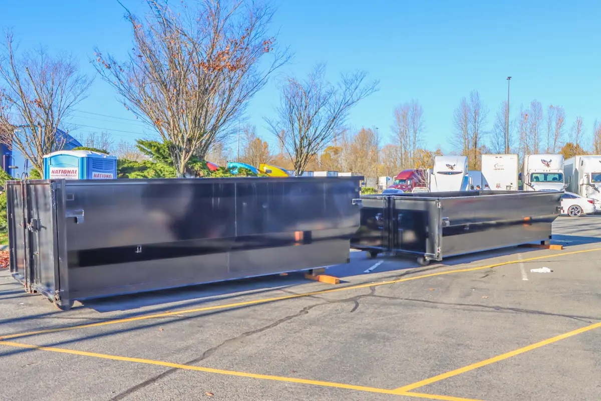 Professional dumpster rental service with roll-off container on residential driveway in Guilderland